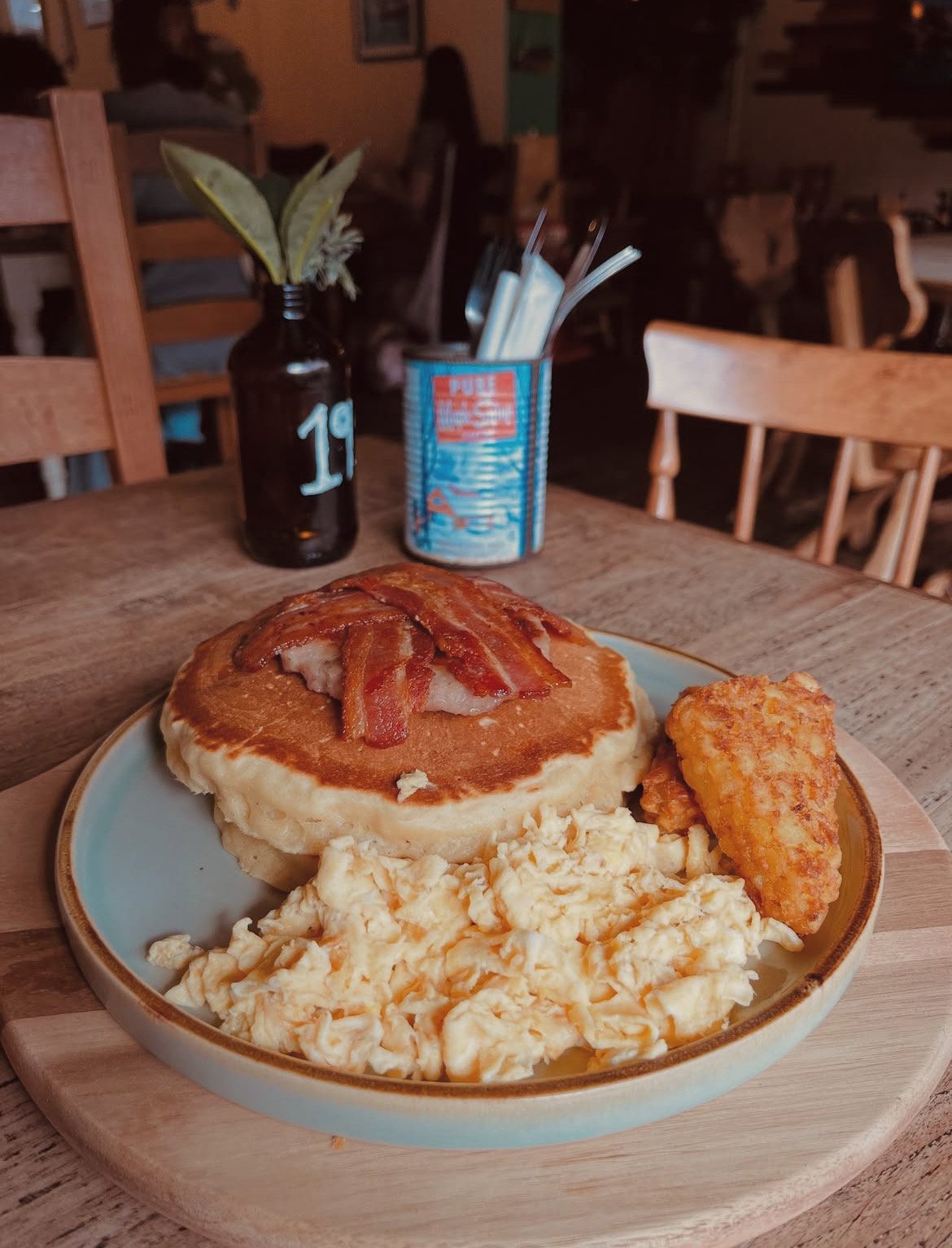 Brunch at The Cabin in Sheffield – a pancake stack topped with bacon, scrambled eggs, hash browns and a sausage Pattie – featuring pancakes, waffles, and cosy café vibes in the city centre